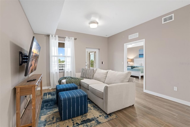 living area featuring wood finished floors and baseboards
