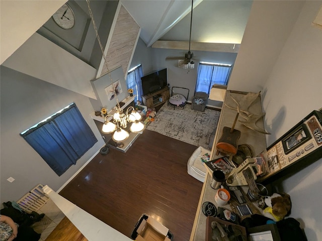 dining area with a ceiling fan, high vaulted ceiling, and wood finished floors