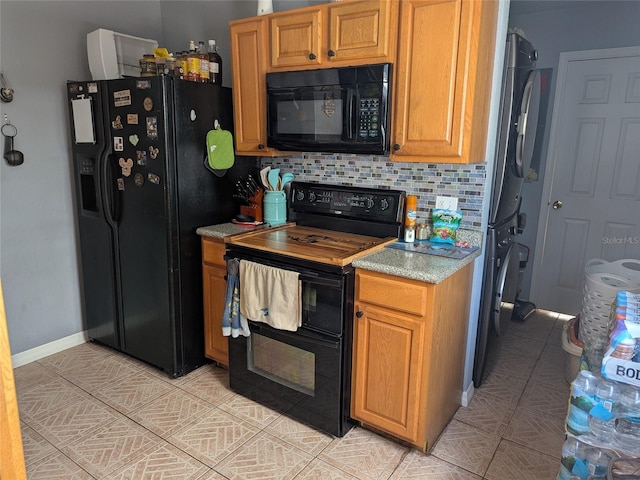 kitchen with backsplash, light tile patterned flooring, black appliances, and light countertops