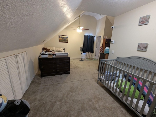 carpeted bedroom featuring a ceiling fan, a textured ceiling, and lofted ceiling
