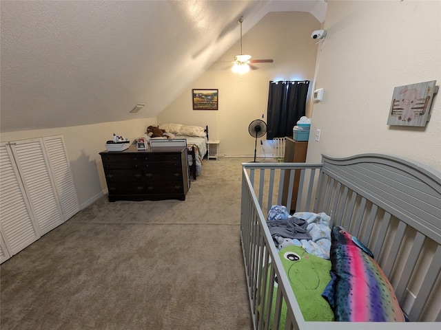 bedroom with carpet floors, ceiling fan, vaulted ceiling, and a textured ceiling