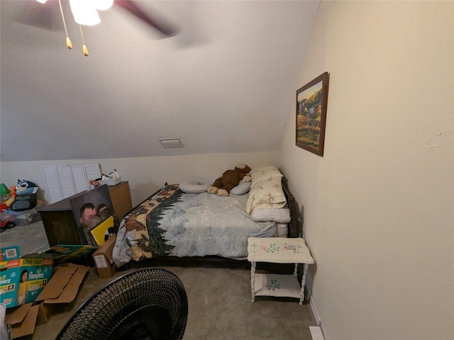 carpeted bedroom featuring a ceiling fan and vaulted ceiling