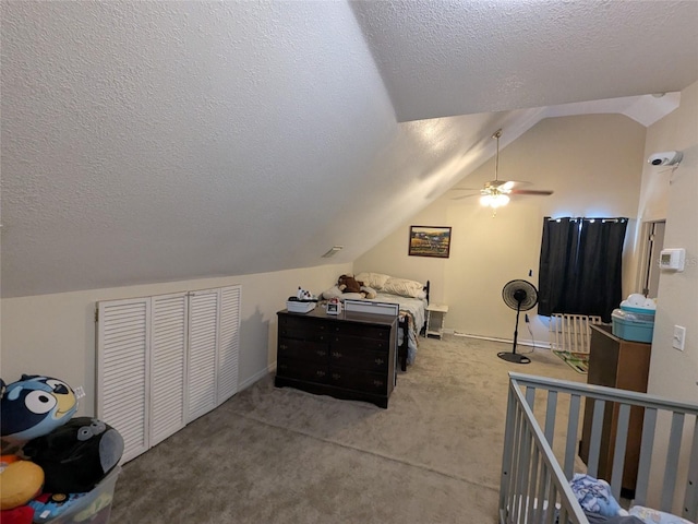 carpeted bedroom featuring ceiling fan, vaulted ceiling, and a textured ceiling