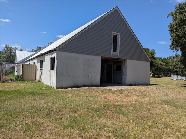 back of house with a lawn