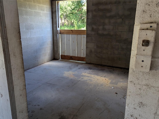 empty room featuring concrete block wall