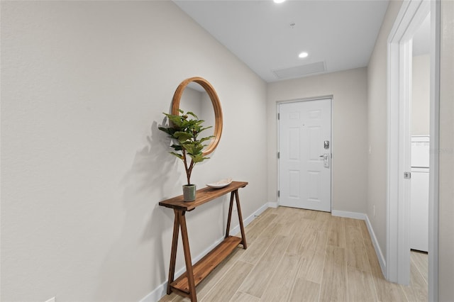 doorway featuring baseboards, light wood finished floors, and recessed lighting