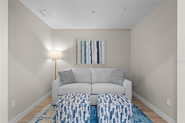 living room featuring baseboards and wood finished floors