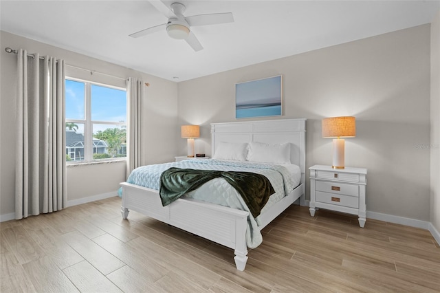 bedroom with baseboards, light wood-style flooring, and ceiling fan