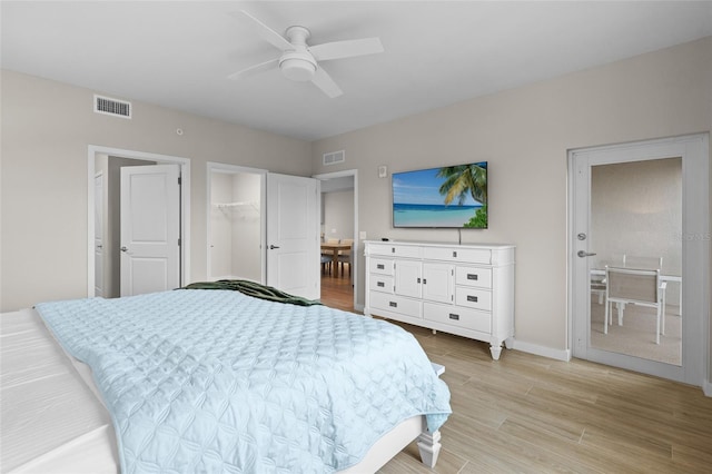 bedroom featuring light wood finished floors, baseboards, and a ceiling fan
