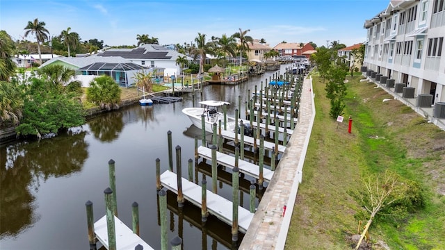 dock area featuring a water view, a residential view, and cooling unit