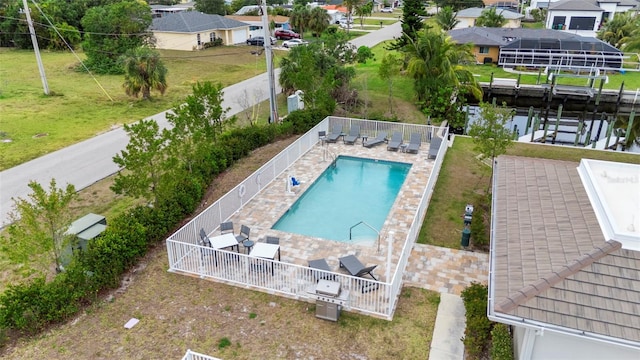 community pool with a residential view, a water view, and a patio