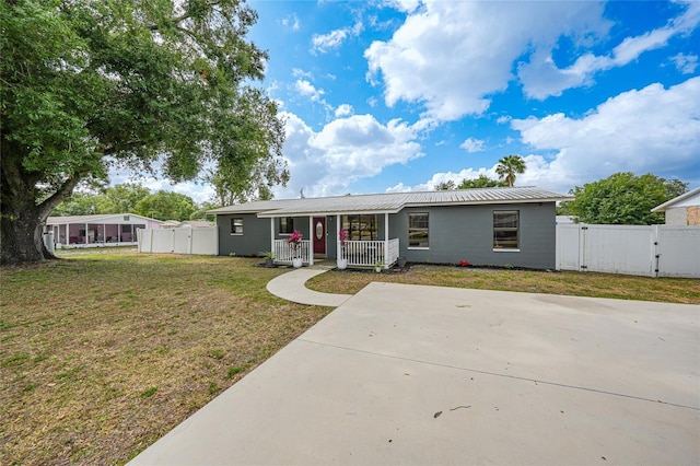 1741 NE Trisha Dr, Arcadia, FL 34266 - ranch-style house featuring a gate, a porch, and metal roof