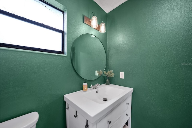 1741 NE Trisha Dr, Arcadia, FL 34266 - half bathroom with vanity, a textured wall, and toilet