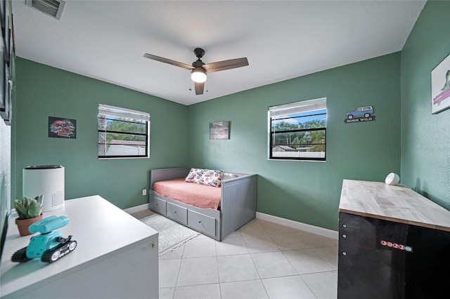 1741 NE Trisha Dr, Arcadia, FL 34266 - bedroom featuring multiple windows, baseboards, light tile patterned flooring, and ceiling fan