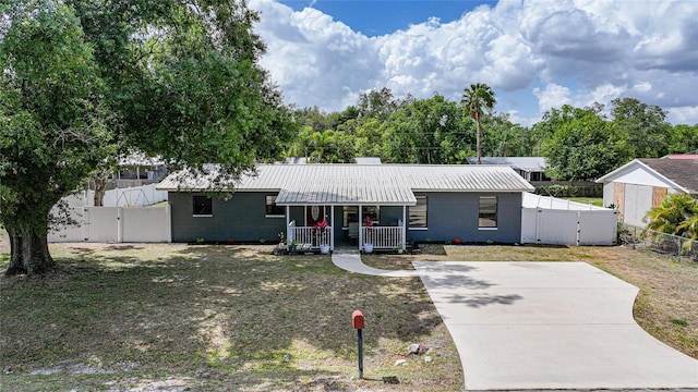 1741 NE Trisha Dr, Arcadia, FL 34266 - view of front of house with a gate, a porch, and metal roof