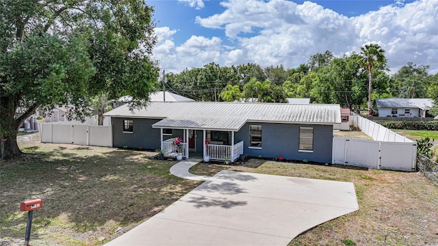 1741 NE Trisha Dr, Arcadia, FL 34266 - ranch-style home featuring a gate, a porch, metal roof, and a fenced backyard