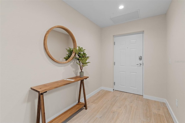 doorway to outside featuring light wood-style flooring and baseboards
