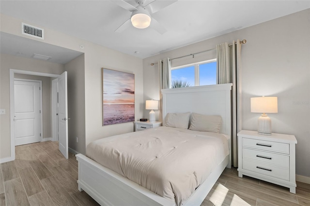 bedroom with light wood-type flooring, baseboards, and a ceiling fan