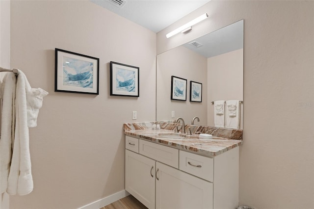 bathroom featuring vanity and wood finished floors
