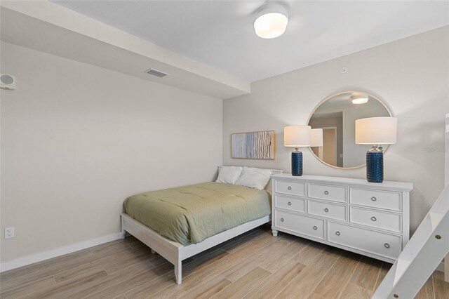 bedroom featuring light wood-type flooring and baseboards