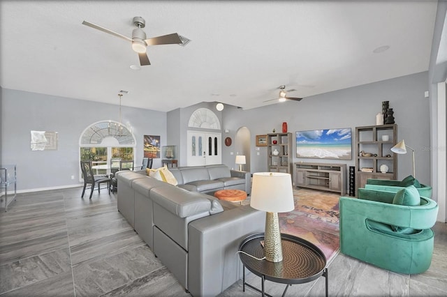 3520 Caya Largo Ct, Punta Gorda, FL 33950 - living room with a ceiling fan, baseboards, vaulted ceiling, and arched walkways