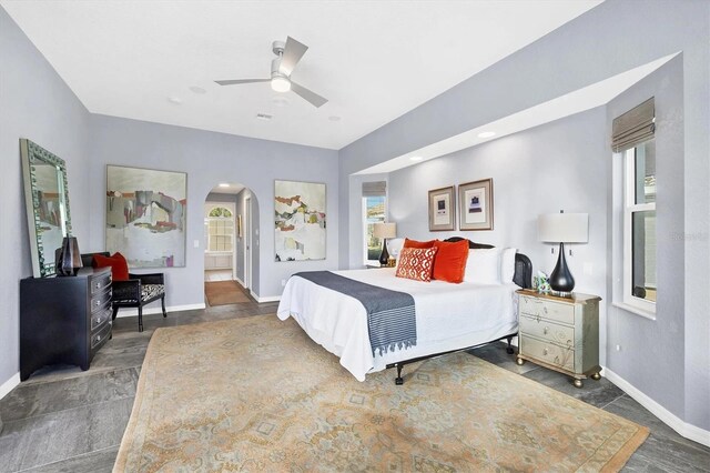 3520 Caya Largo Ct, Punta Gorda, FL 33950 - bedroom with baseboards, multiple windows, arched walkways, and a ceiling fan