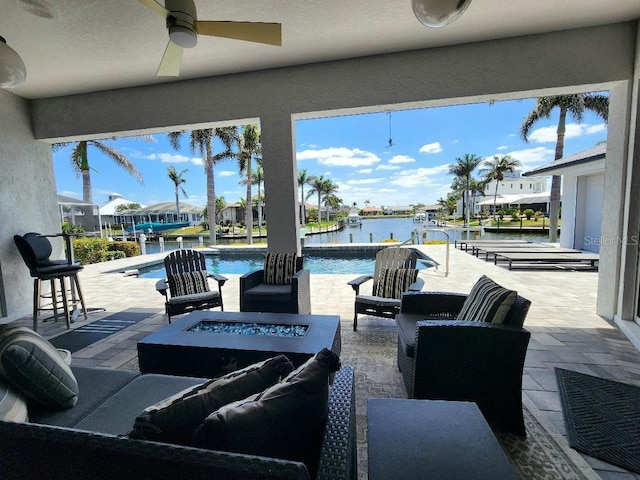 3520 Caya Largo Ct, Punta Gorda, FL 33950 - view of patio with a water view, an outdoor pool, and an outdoor living space with a fire pit