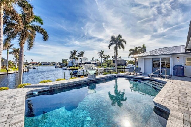 3520 Caya Largo Ct, Punta Gorda, FL 33950 - swimming pool featuring a water view, a dock, and a patio