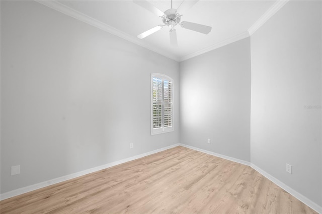 spare room featuring baseboards, ornamental molding, a ceiling fan, and light wood-style flooring