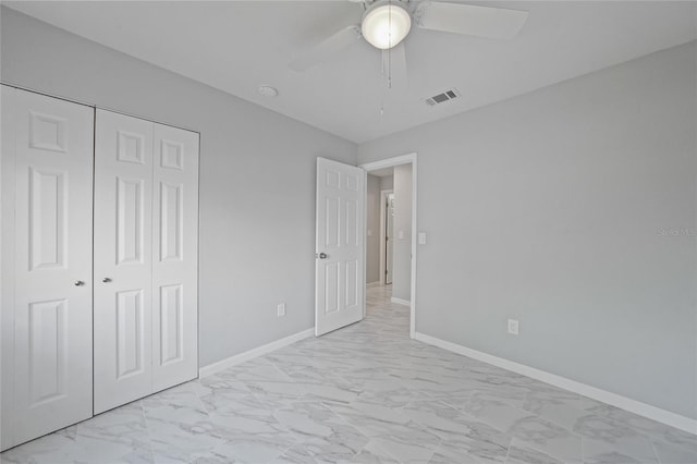 unfurnished bedroom featuring a ceiling fan, visible vents, baseboards, a closet, and marble finish floor