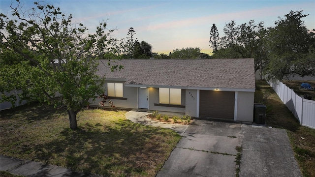 single story home featuring fence, a shingled roof, stucco siding, and aphalt driveway