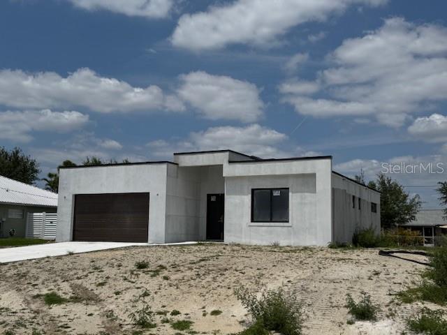 modern home with an attached garage and concrete driveway