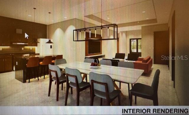 carpeted dining space with wallpapered walls