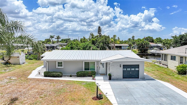 27385 Voyageur Dr, Punta Gorda, FL 33983 - ranch-style home with an attached garage, stucco siding, a front lawn, driveway, and metal roof