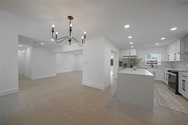 27385 Voyageur Dr, Punta Gorda, FL 33983 - kitchen with black / electric stove, a chandelier, stainless steel refrigerator with ice dispenser, a center island, and backsplash