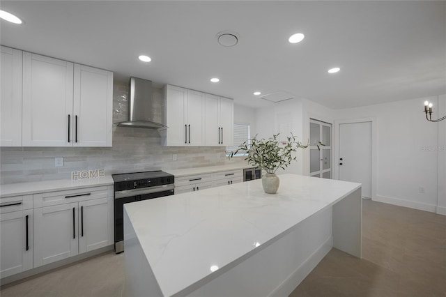 27385 Voyageur Dr, Punta Gorda, FL 33983 - kitchen featuring stainless steel electric stove, wall chimney exhaust hood, decorative backsplash, white cabinets, and recessed lighting