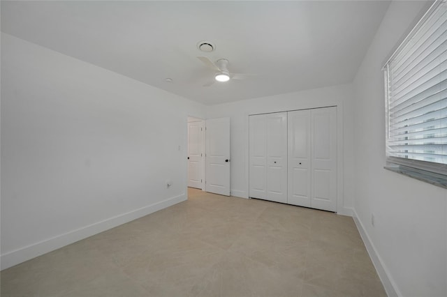 27385 Voyageur Dr, Punta Gorda, FL 33983 - unfurnished bedroom with baseboards, a closet, and a ceiling fan