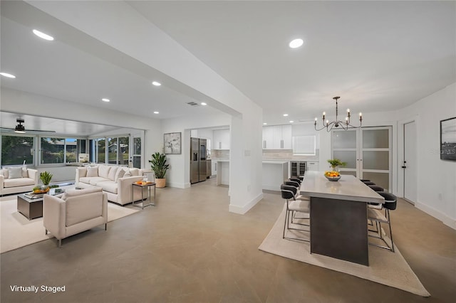27385 Voyageur Dr, Punta Gorda, FL 33983 - dining space featuring recessed lighting, baseboards, a chandelier, a ceiling fan, and finished concrete flooring