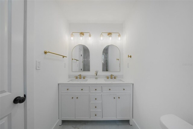 27385 Voyageur Dr, Punta Gorda, FL 33983 - bathroom featuring baseboards, toilet, and double vanity