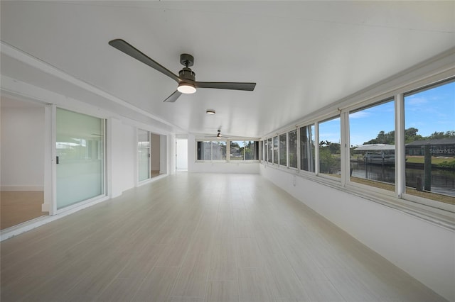 27385 Voyageur Dr, Punta Gorda, FL 33983 - unfurnished sunroom featuring a water view and baseboards