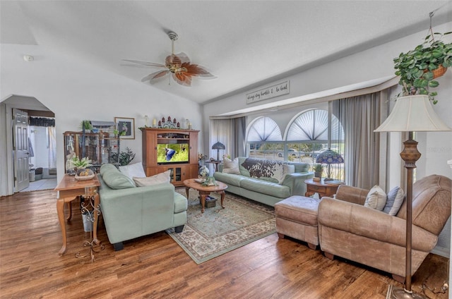 living area with ceiling fan, wood finished floors, and lofted ceiling