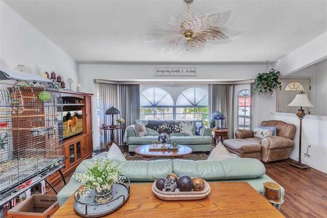 living area with plenty of natural light and wood finished floors