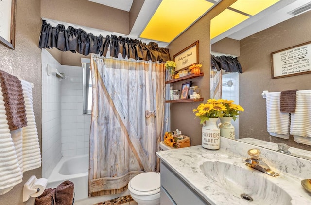 full bathroom with toilet, a textured wall, shower / tub combination, and vanity