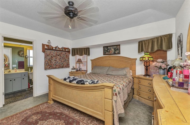 bedroom with a sink, carpet, and ensuite bath