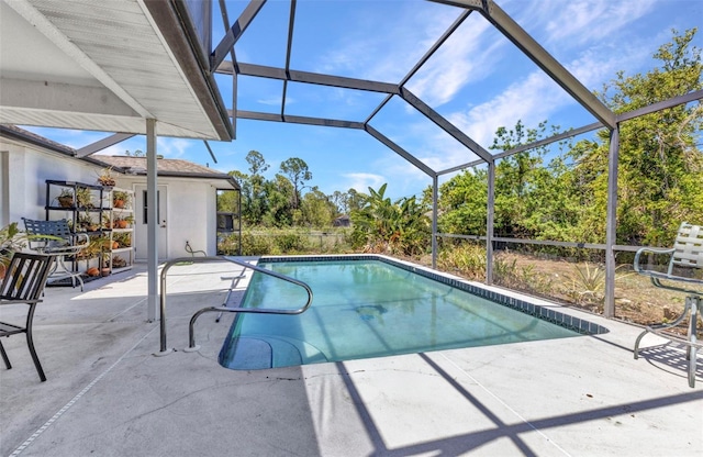 pool with glass enclosure and a patio