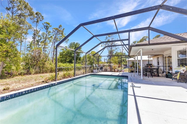 outdoor pool with a lanai and a patio