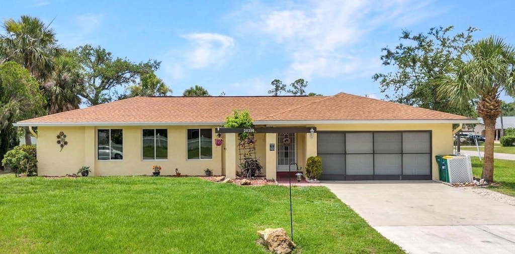 20355 Mount Prospect Ave, Port Charlotte, FL 33952 - ranch-style home featuring stucco siding, an attached garage, concrete driveway, and a front lawn