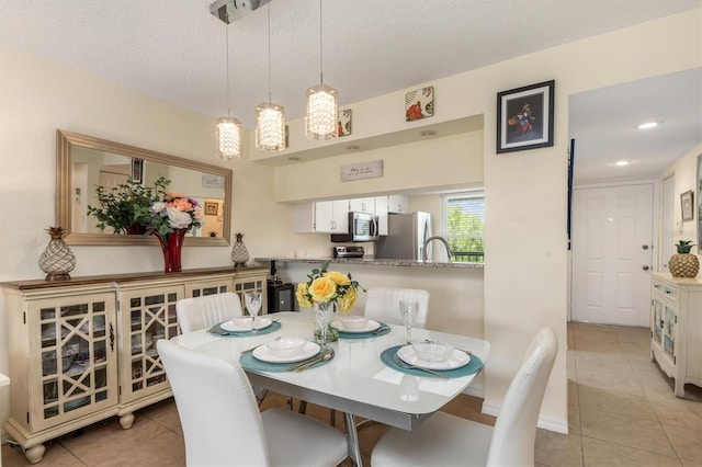 dining room featuring recessed lighting, a textured ceiling, and light tile patterned floors