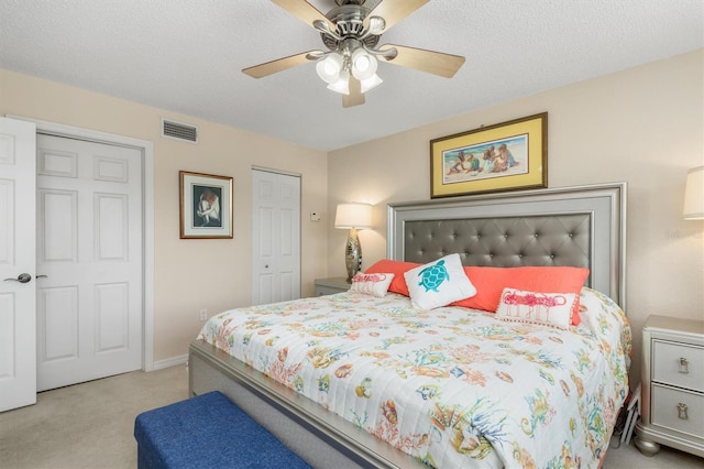 bedroom with ceiling fan, carpet floors, baseboards, visible vents, and a closet