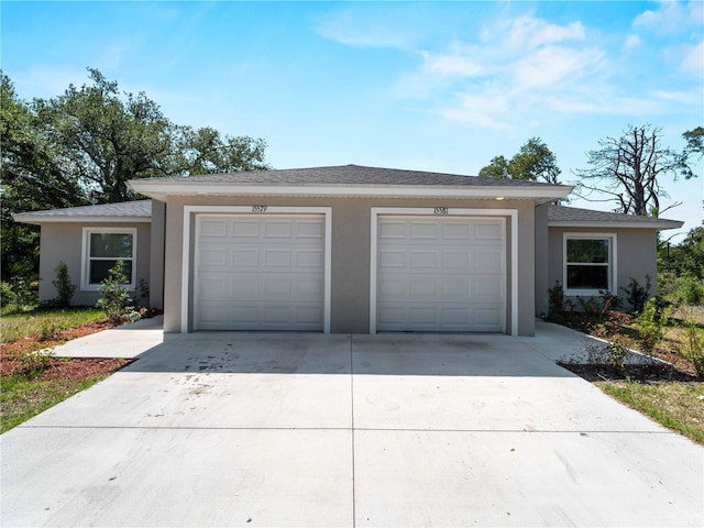 15579/15581 Chamberlain Blvd, Port Charlotte, FL 33953 - view of front of home featuring a garage, driveway, and stucco siding